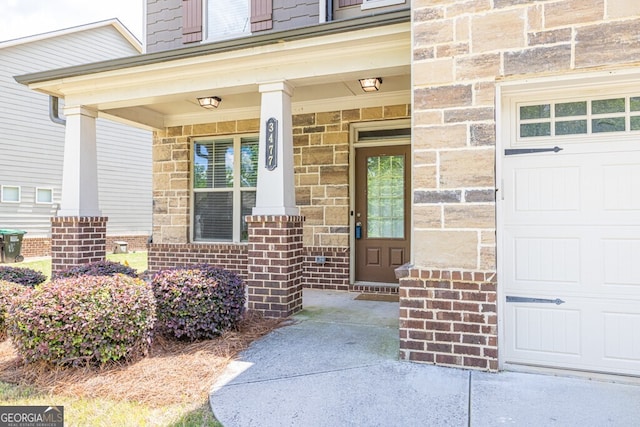 entrance to property with covered porch and brick siding
