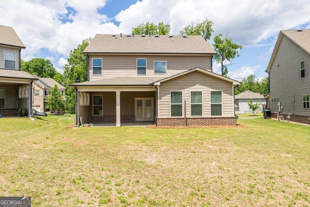 back of house with a yard, french doors, and a patio area