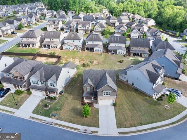 aerial view of property and surrounding area with nearby suburban area