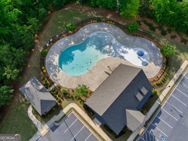 view of subject property with a pool area