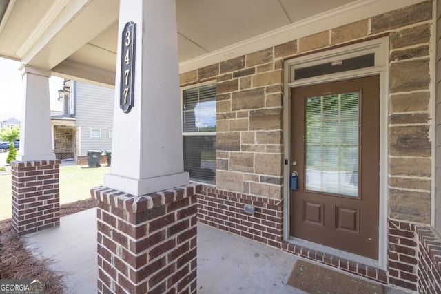 view of exterior entry with a porch