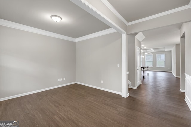 empty room with dark wood-style flooring, crown molding, baseboards, and ceiling fan