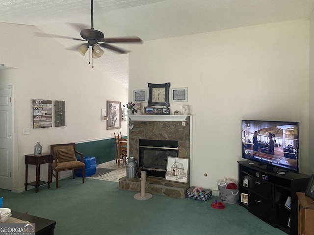 248 Fern Ct, Hampton, GA 30228 - living room featuring carpet, a ceiling fan, a textured ceiling, a stone fireplace, and vaulted ceiling