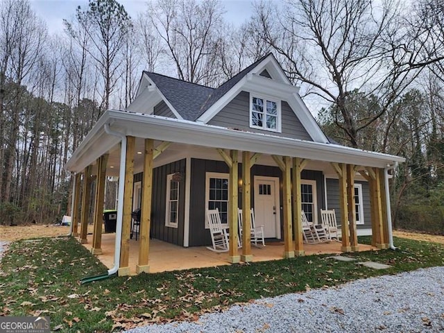40 Luther Knight Rd, Cartersville, GA 30121 - view of front of home with board and batten siding, a porch, and roof with shingles