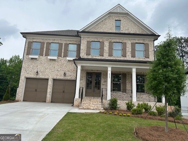 5247 Flannery Chase SW, Powder Springs, GA 30127 - view of front of property featuring an attached garage, driveway, covered porch, a front yard, and brick siding