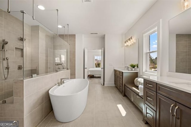 5247 Flannery Chase SW, Powder Springs, GA 30127 - full bath featuring a tile shower, two vanities, tile patterned floors, a freestanding bath, and recessed lighting