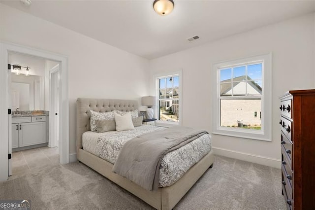 5247 Flannery Chase SW, Powder Springs, GA 30127 - bedroom with light carpet, baseboards, ensuite bathroom, and a sink