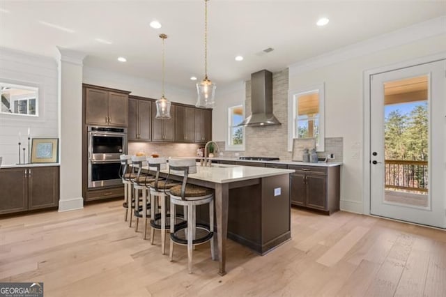 5247 Flannery Chase SW, Powder Springs, GA 30127 - kitchen with wall chimney range hood, a sink, double oven, light countertops, and dark brown cabinets