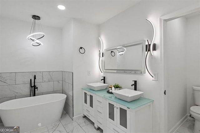 3634 Oakleaf Pass, Fairburn, GA 30213 - full bathroom featuring toilet, marble finish floor, a soaking tub, and a sink