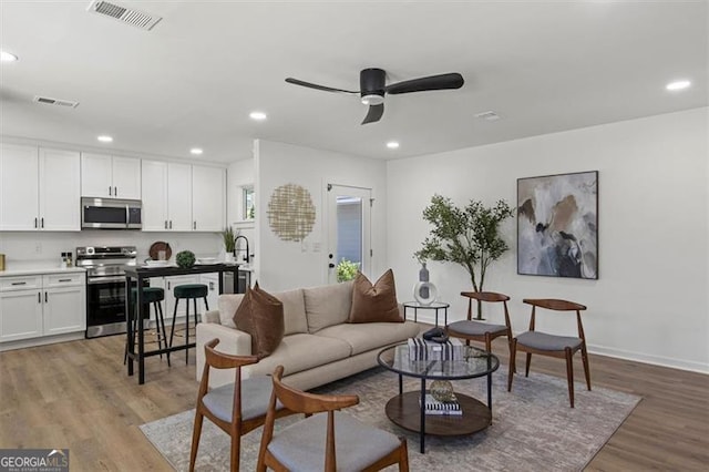 3634 Oakleaf Pass, Fairburn, GA 30213 - living room featuring light wood-type flooring, recessed lighting, visible vents, and a ceiling fan