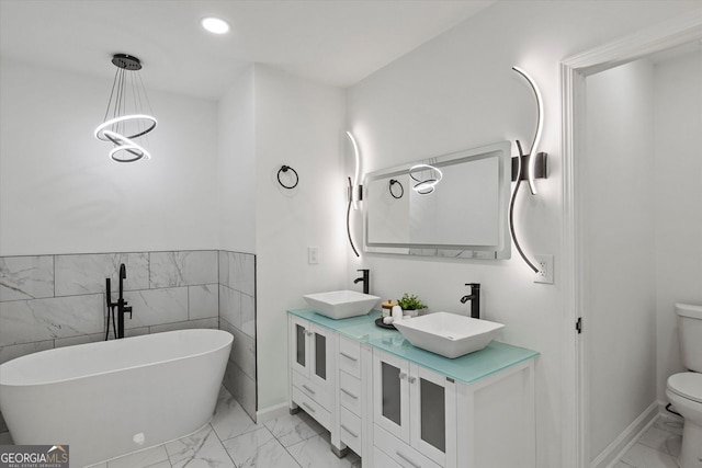 3634 Oakleaf Pass, Fairburn, GA 30213 - full bathroom featuring toilet, marble finish floor, a freestanding bath, and a sink