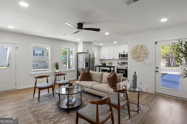 3634 Oakleaf Pass, Fairburn, GA 30213 - living area featuring visible vents, recessed lighting, light wood finished floors, a ceiling fan, and baseboards