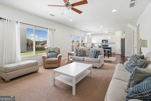 living room with ceiling fan, recessed lighting, and baseboards