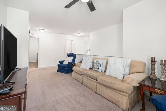 living room featuring ceiling fan, carpet floors, and baseboards