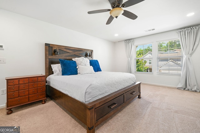bedroom featuring light carpet, recessed lighting, baseboards, and a ceiling fan