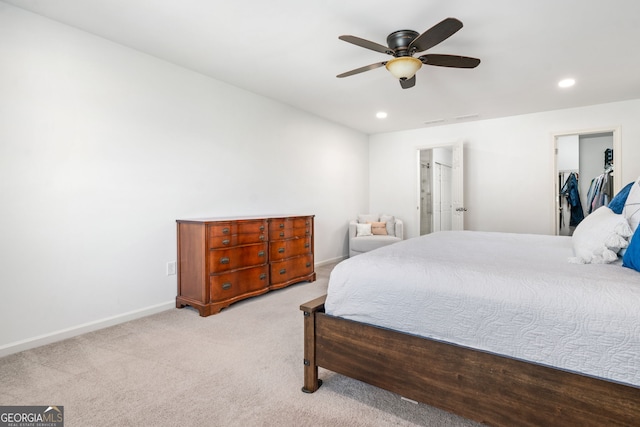 bedroom featuring carpet floors, recessed lighting, baseboards, ceiling fan, and a walk in closet