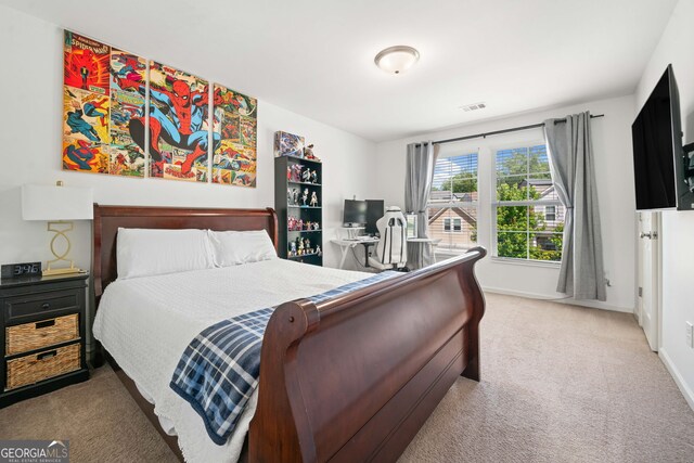 bedroom with carpet flooring and baseboards