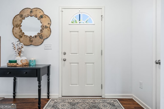 entrance foyer featuring dark wood-style floors and baseboards