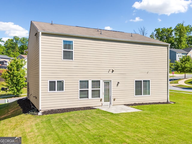 back of property featuring a yard