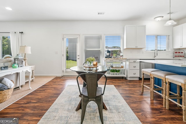 kitchen featuring dishwasher, healthy amount of natural light, tasteful backsplash, light countertops, and recessed lighting