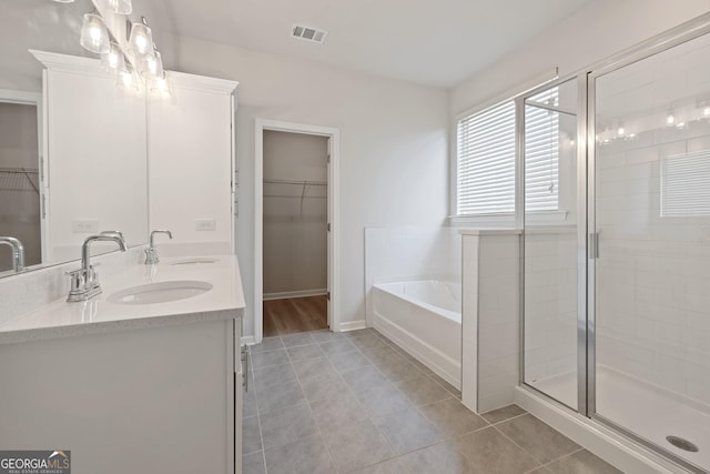 full bath featuring a bath, visible vents, tile patterned flooring, and a sink