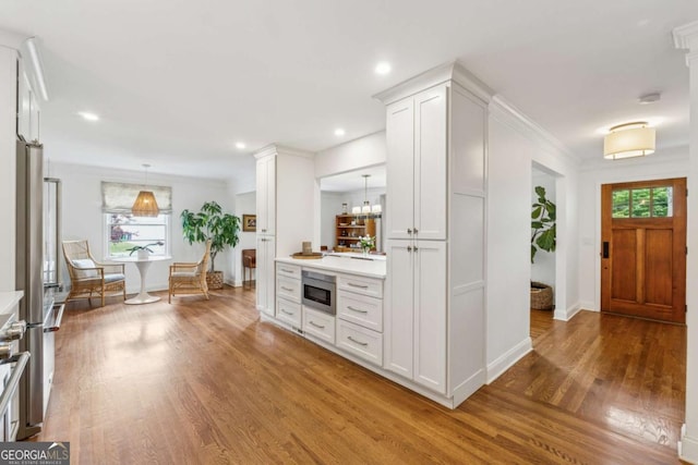 foyer featuring wood finished floors, plenty of natural light, baseboards, and recessed lighting