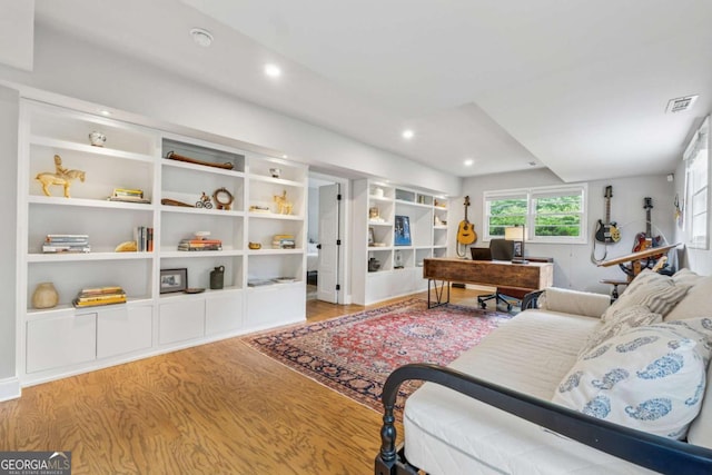 living area with wood finished floors, recessed lighting, and an office area