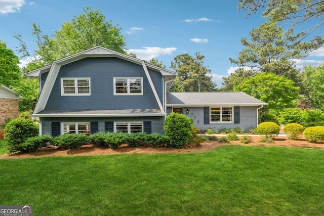 tri-level home featuring a front lawn and a gambrel roof