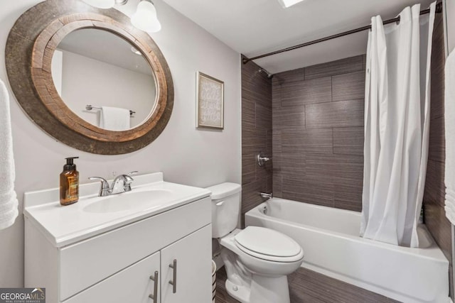 full bath with shower / bath combination with curtain, toilet, and vanity