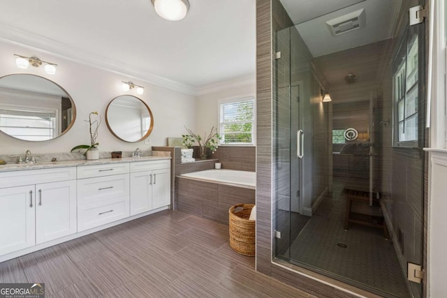 full bathroom with a garden tub, a shower stall, double vanity, ornamental molding, and tile patterned flooring
