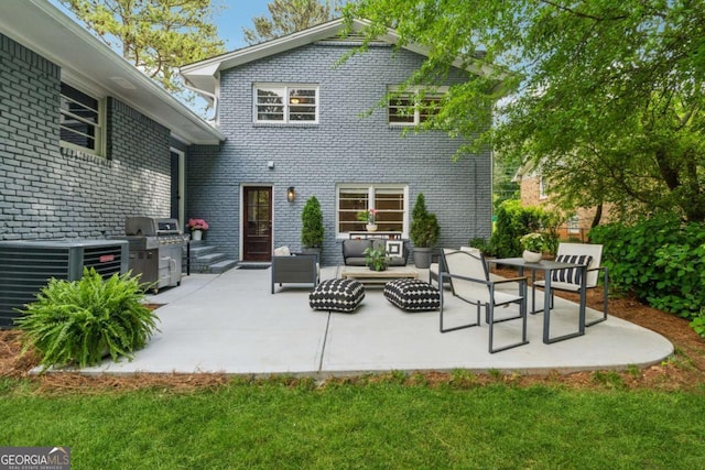 back of property with a patio area, outdoor lounge area, and brick siding