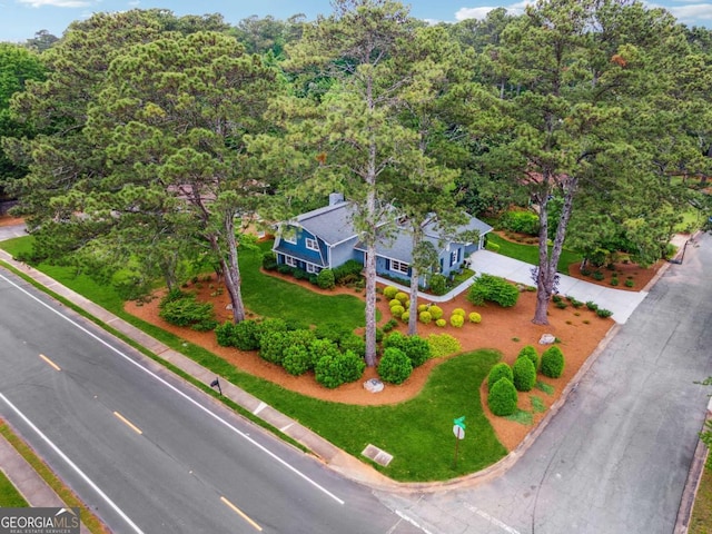 aerial view of property and surrounding area featuring a forest