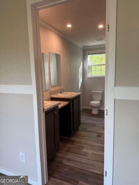 236 Dewaters Rd, Commerce, GA 30529 - bathroom with vanity, toilet, wood finished floors, recessed lighting, and baseboards