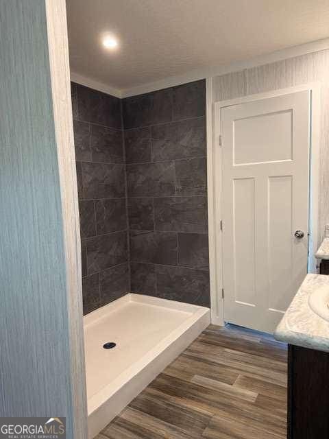 236 Dewaters Rd, Commerce, GA 30529 - full bathroom with a stall shower, wood finished floors, vanity, and ornamental molding