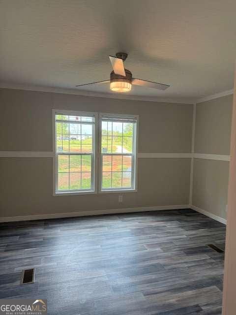 236 Dewaters Rd, Commerce, GA 30529 - unfurnished room with ornamental molding, ceiling fan, wood finished floors, and baseboards