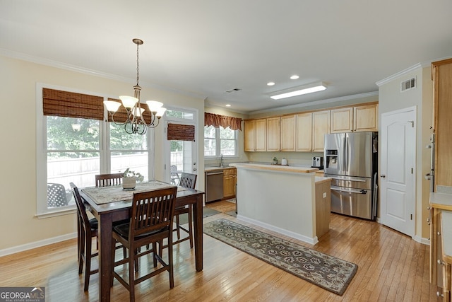 kitchen with crown molding, light countertops, visible vents, and appliances with stainless steel finishes