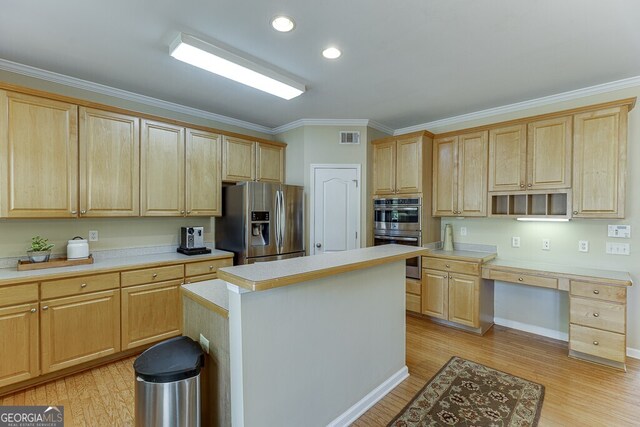 kitchen featuring stainless steel appliances, light brown cabinets, light countertops, and visible vents