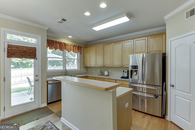 kitchen with stainless steel appliances, light wood-type flooring, visible vents, light countertops, and light brown cabinets