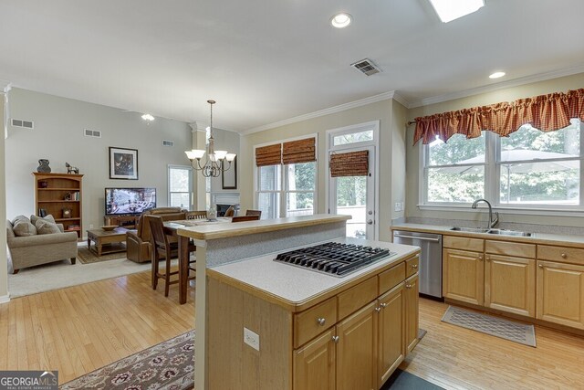kitchen with light wood-type flooring, stainless steel appliances, visible vents, and a sink