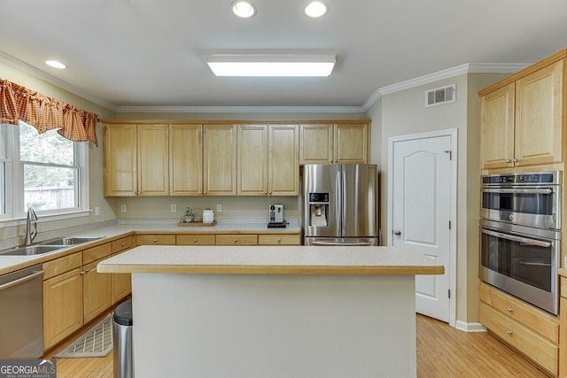 kitchen featuring a sink, visible vents, light brown cabinetry, light countertops, and appliances with stainless steel finishes