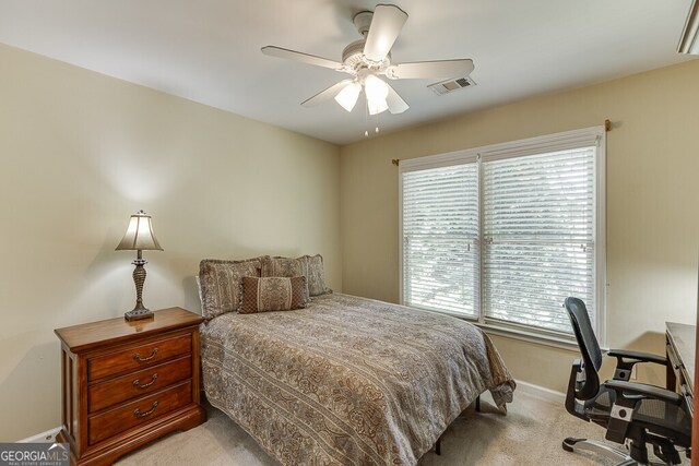 bedroom featuring baseboards, multiple windows, light carpet, and visible vents
