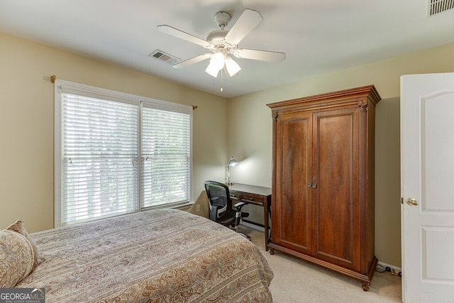 bedroom featuring light colored carpet, a ceiling fan, and visible vents