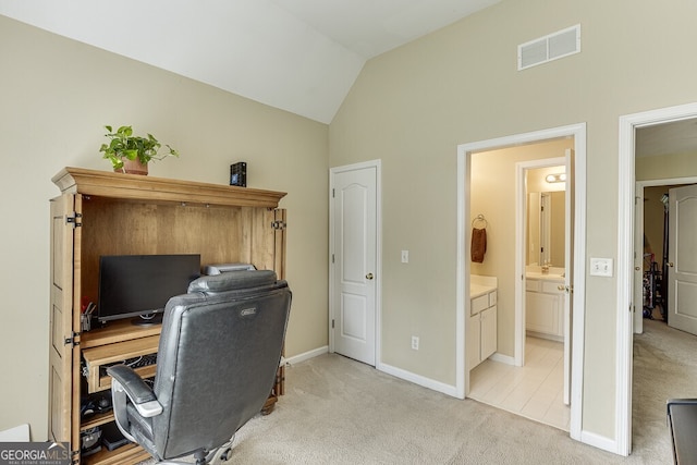 home office featuring vaulted ceiling, light colored carpet, baseboards, and visible vents