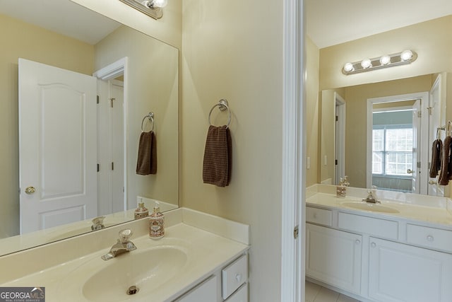 bathroom featuring a sink and two vanities
