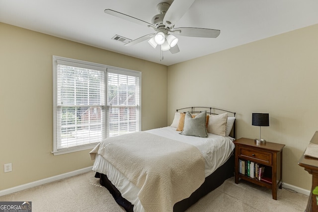 carpeted bedroom featuring visible vents, baseboards, and ceiling fan