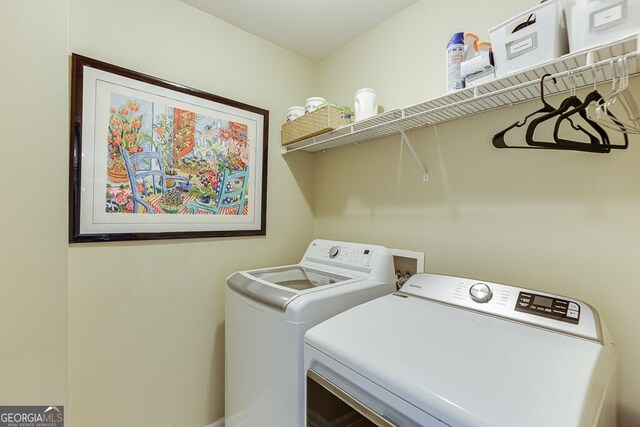 laundry area featuring separate washer and dryer and laundry area