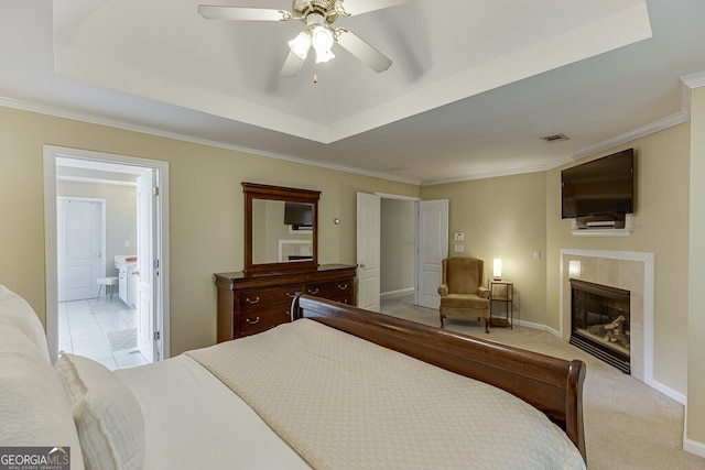 bedroom featuring baseboards, ensuite bathroom, ornamental molding, visible vents, and a fireplace