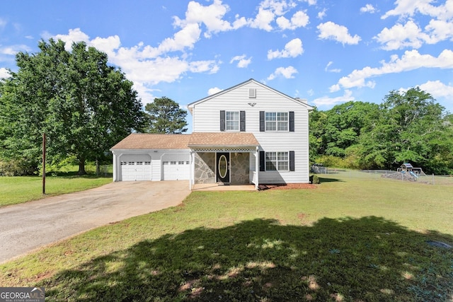 traditional home featuring a front lawn, driveway, and a garage