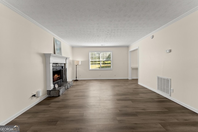 unfurnished living room featuring a textured ceiling, visible vents, a warm lit fireplace, and ornamental molding