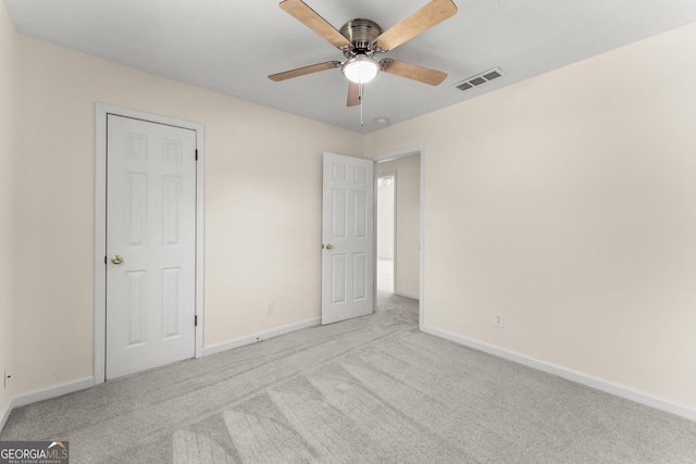 unfurnished bedroom with ceiling fan, carpet flooring, baseboards, and visible vents